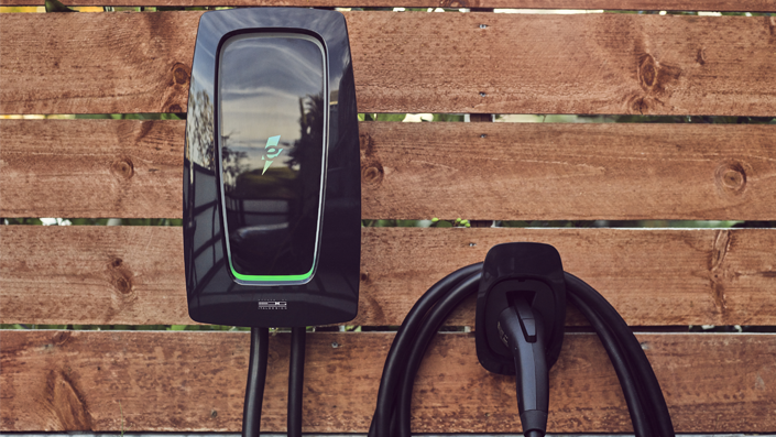 residential ev charging station on wooden plank wall